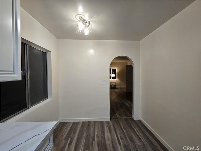 9412 Haney St, Pico Rivera, CA 90660 - hall featuring arched walkways, dark wood-style floors, and baseboards