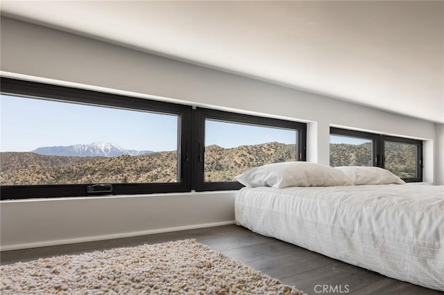 bedroom featuring baseboards and wood finished floors