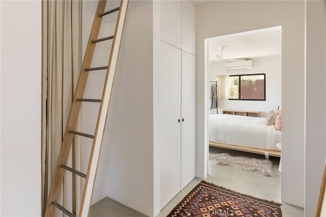 interior space featuring finished concrete floors and a wall mounted air conditioner