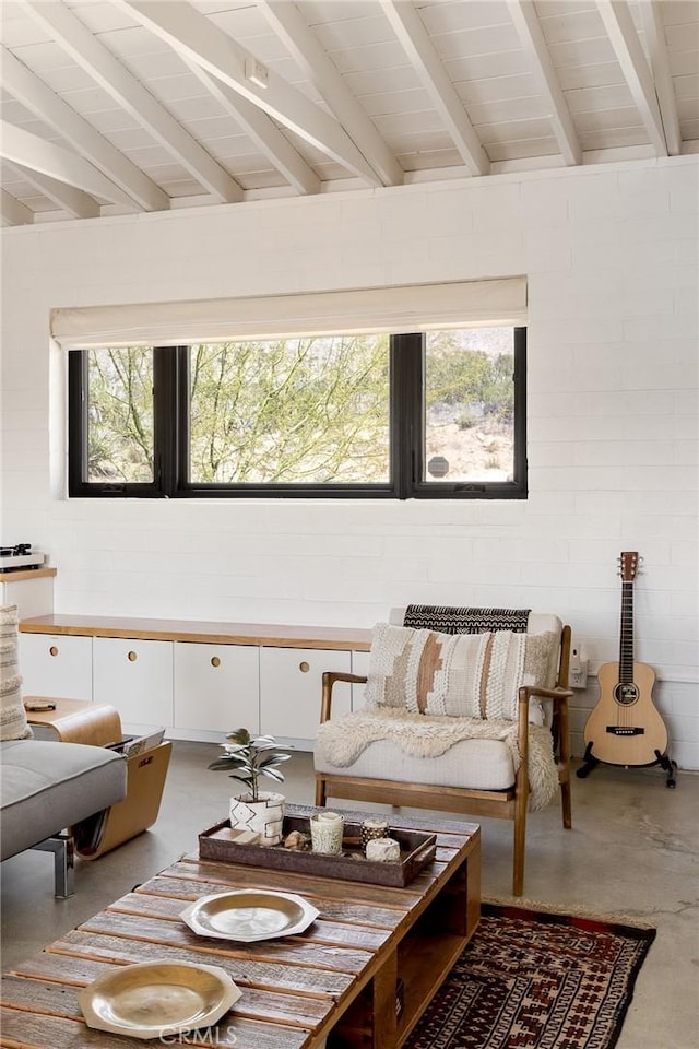 48575 Paradise Ave, Morongo Valley, CA 92256 - living room with healthy amount of natural light, finished concrete flooring, and beamed ceiling