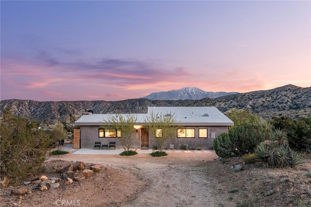 48575 Paradise Ave, Morongo Valley, CA 92256 - ranch-style house featuring a patio, stucco siding, a mountain view, and a chimney