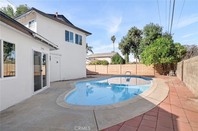 view of swimming pool featuring a fenced in pool, a fenced backyard, and a patio area