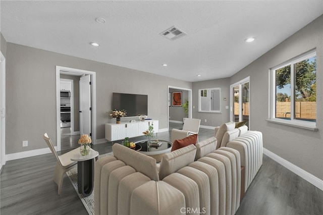living room with recessed lighting, baseboards, visible vents, and wood finished floors