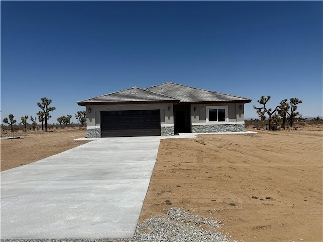 6472 Cayucos Dr, Phelan, CA 92371 - view of front of property with a garage, stone siding, and driveway