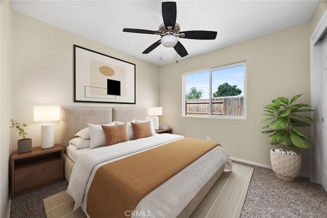bedroom with baseboards, a ceiling fan, and carpet flooring