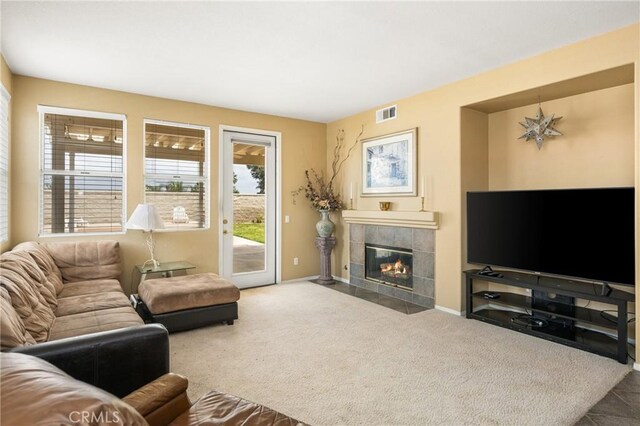 833 W Orange Heights Ln, Corona, CA 92882 - living area featuring a tile fireplace, baseboards, and carpet floors