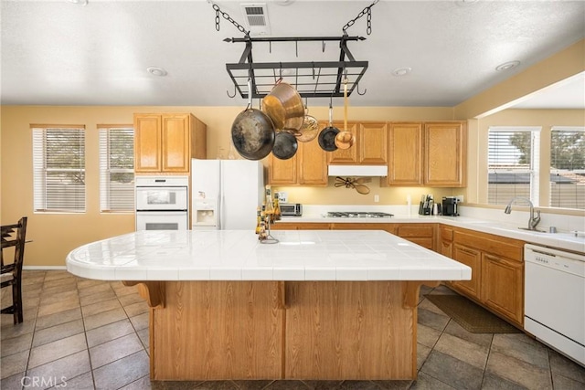 833 W Orange Heights Ln, Corona, CA 92882 - kitchen with white appliances, a sink, tile countertops, and under cabinet range hood