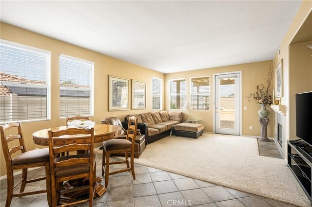 833 W Orange Heights Ln, Corona, CA 92882 - living room featuring light colored carpet, plenty of natural light, light tile patterned flooring, and baseboards