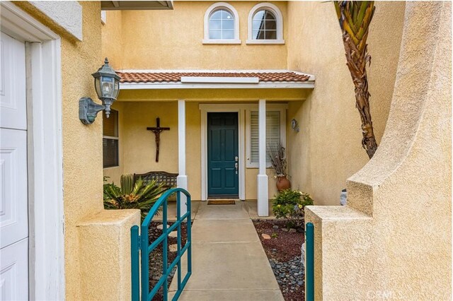 833 W Orange Heights Ln, Corona, CA 92882 - view of exterior entry with stucco siding and a porch