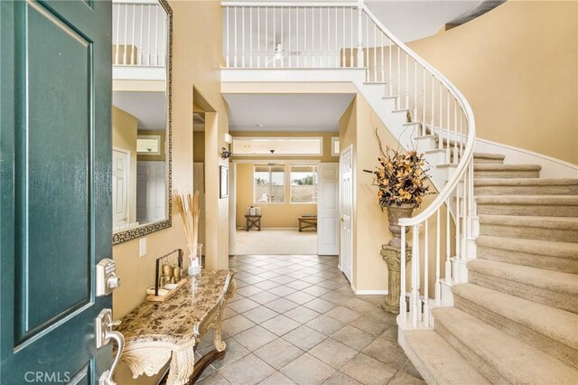 833 W Orange Heights Ln, Corona, CA 92882 - foyer entrance featuring stairs, tile patterned floors, a towering ceiling, and baseboards