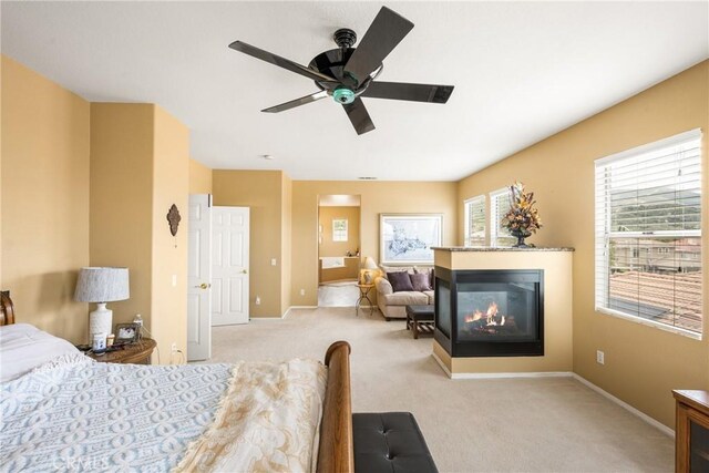 833 W Orange Heights Ln, Corona, CA 92882 - carpeted bedroom featuring a multi sided fireplace, baseboards, a ceiling fan, and ensuite bath