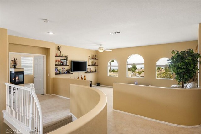 833 W Orange Heights Ln, Corona, CA 92882 - living area featuring light colored carpet, ceiling fan, a multi sided fireplace, and baseboards