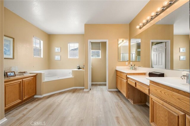 833 W Orange Heights Ln, Corona, CA 92882 - bathroom with wood finished floors, a bath, and vanity