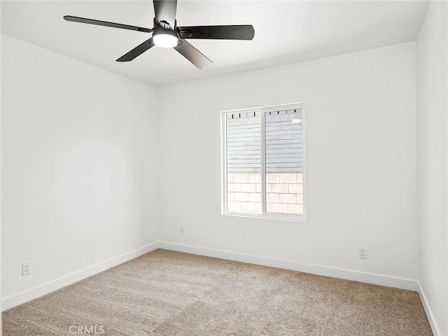 unfurnished room featuring baseboards, a ceiling fan, and light colored carpet