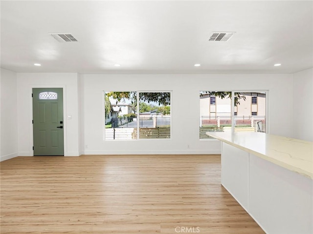entryway featuring a healthy amount of sunlight, recessed lighting, light wood-style flooring, and visible vents