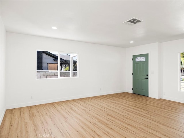 interior space with visible vents, light wood-style flooring, and baseboards