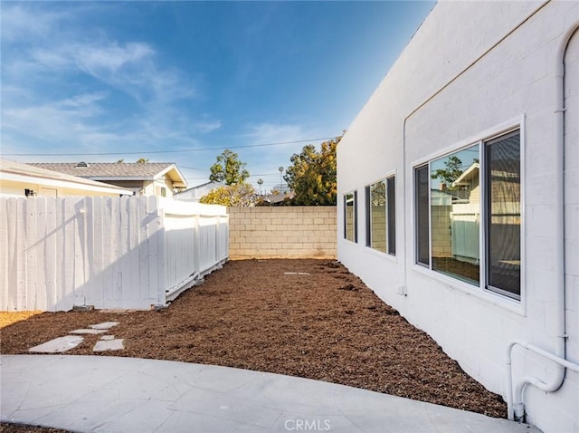 view of yard with fence and a patio