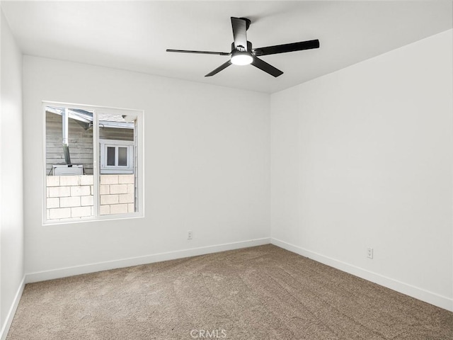 carpeted empty room with baseboards and ceiling fan