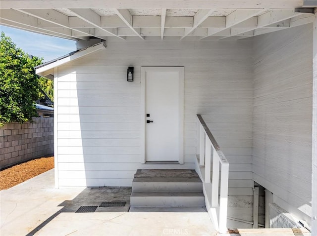 doorway to property featuring fence