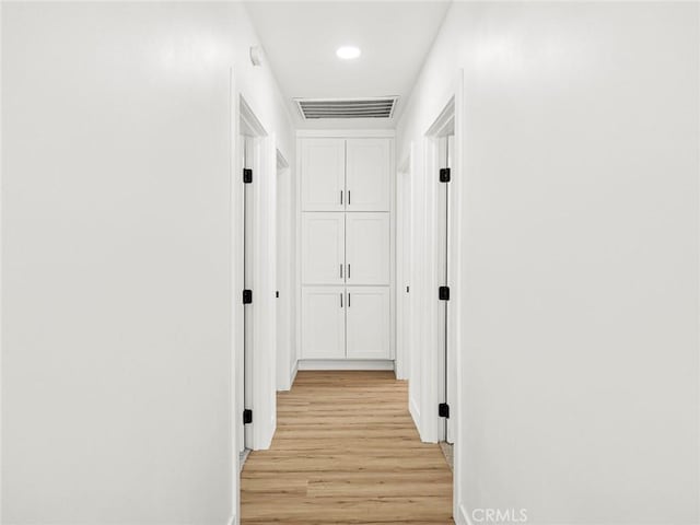 hallway featuring recessed lighting, baseboards, visible vents, and light wood-type flooring