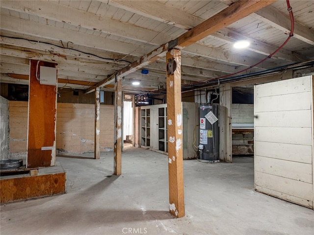 unfinished basement featuring gas water heater