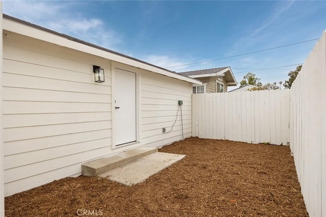 doorway to property featuring fence