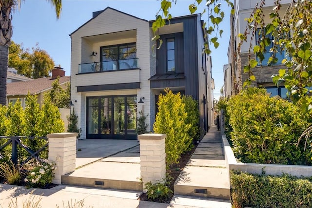 contemporary home with fence and a balcony