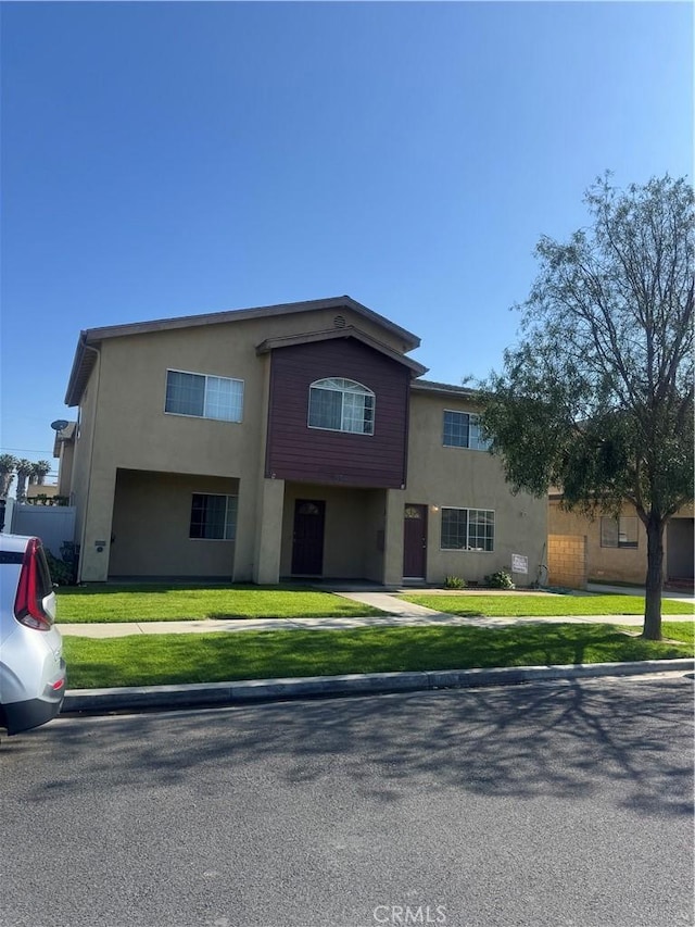 4302 Howard Ave Unit 5, Los Alamitos, CA 90720 - view of front of home with stucco siding and a front lawn
