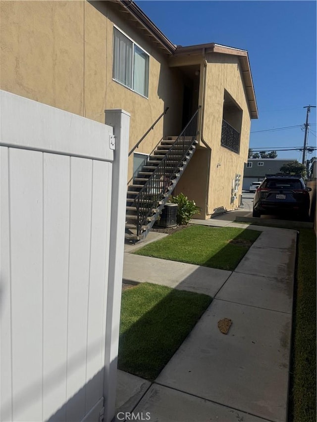 4302 Howard Ave Unit 5, Los Alamitos, CA 90720 - view of property exterior featuring stairs, stucco siding, and cooling unit