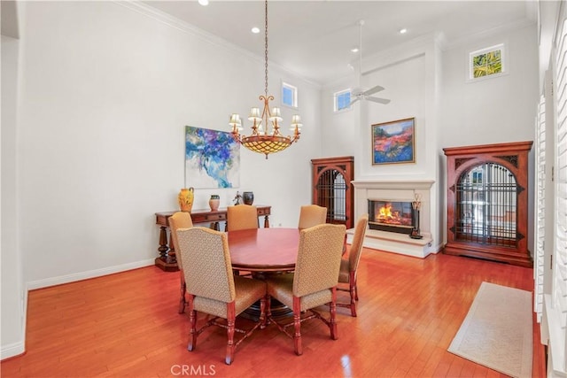 1925 Katie Ct, Fallbrook, CA 92028 - dining room with crown molding, a glass covered fireplace, wood finished floors, a chandelier, and baseboards