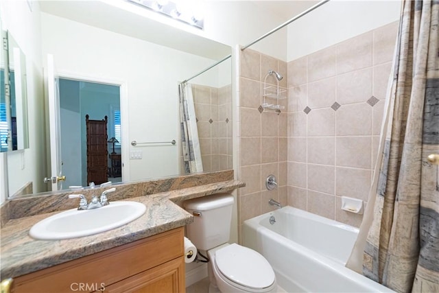 full bathroom with vanity, shower / bath combination with curtain, and toilet