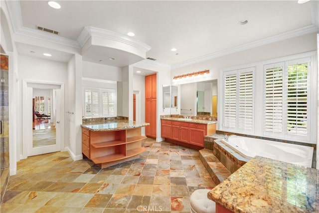 bathroom with a healthy amount of sunlight, ornamental molding, and visible vents