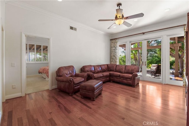 living room with ceiling fan, french doors, visible vents, crown molding, and light wood-style floors