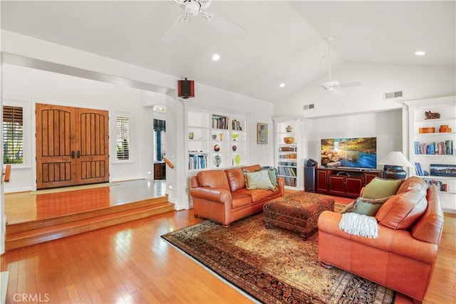 living area featuring visible vents, a ceiling fan, and hardwood / wood-style flooring