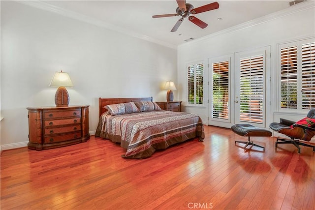bedroom with visible vents, ornamental molding, ceiling fan, access to outside, and hardwood / wood-style flooring