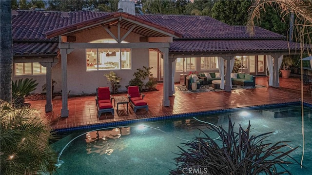 1925 Katie Ct, Fallbrook, CA 92028 - back of house with a tile roof, an outdoor hangout area, an outdoor pool, stucco siding, and a patio area
