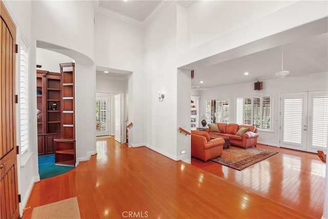 1925 Katie Ct, Fallbrook, CA 92028 - living area with arched walkways, hardwood / wood-style flooring, baseboards, ceiling fan, and crown molding