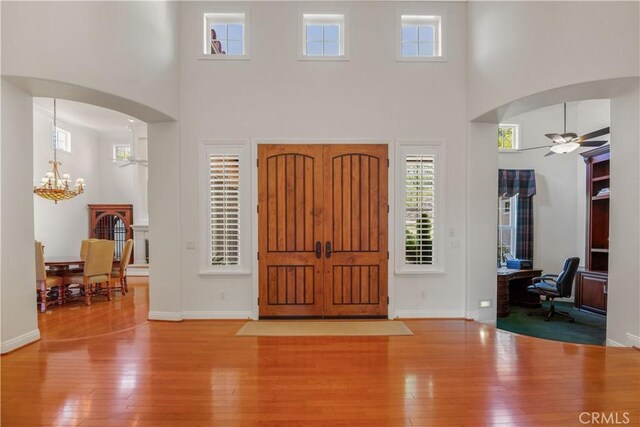 1925 Katie Ct, Fallbrook, CA 92028 - entryway with a towering ceiling, ceiling fan, arched walkways, a chandelier, and hardwood / wood-style flooring