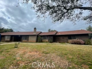 back of house with a lawn