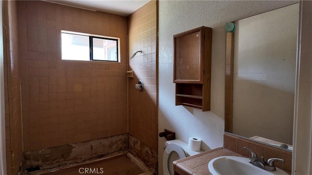 full bathroom featuring vanity, toilet, and a shower stall