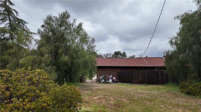view of side of property featuring fence