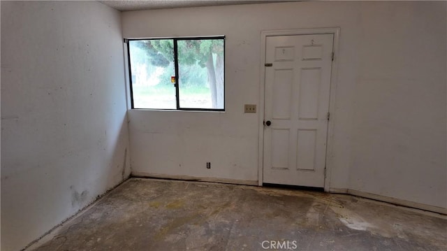 empty room with concrete flooring