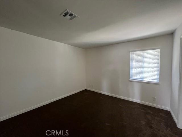 14675 Red Hill Ave, Tustin, CA 92780 - spare room featuring visible vents, baseboards, and dark colored carpet