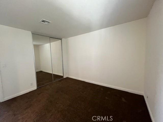 14675 Red Hill Ave, Tustin, CA 92780 - unfurnished bedroom featuring a closet, baseboards, carpet flooring, and visible vents