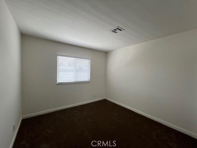 14675 Red Hill Ave, Tustin, CA 92780 - empty room with baseboards, dark colored carpet, and visible vents