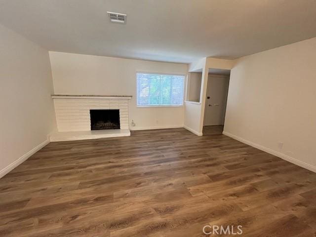14675 Red Hill Ave, Tustin, CA 92780 - unfurnished living room with baseboards, visible vents, wood finished floors, and a fireplace
