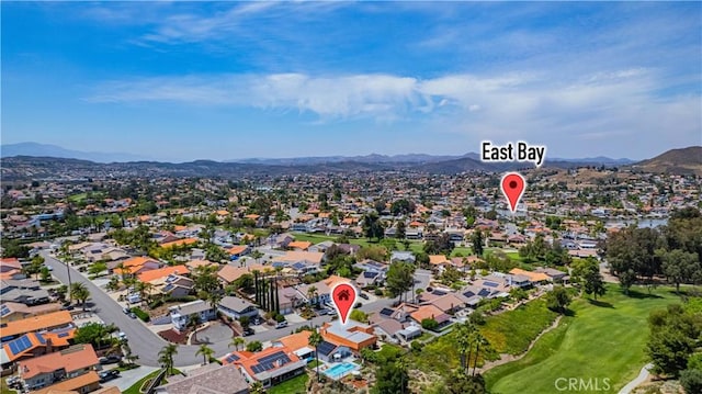 aerial view with a residential view, a mountain view, and golf course view