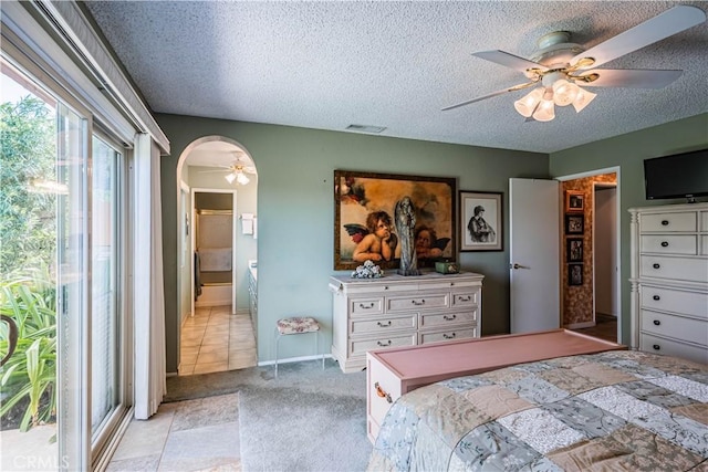 bedroom featuring visible vents, light carpet, access to exterior, ceiling fan, and a textured ceiling