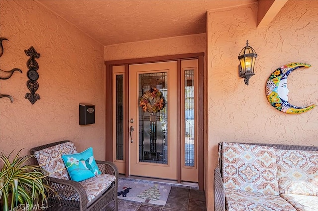 view of exterior entry featuring stucco siding
