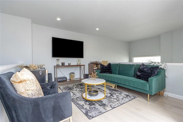 living area featuring recessed lighting, baseboards, and wood finished floors